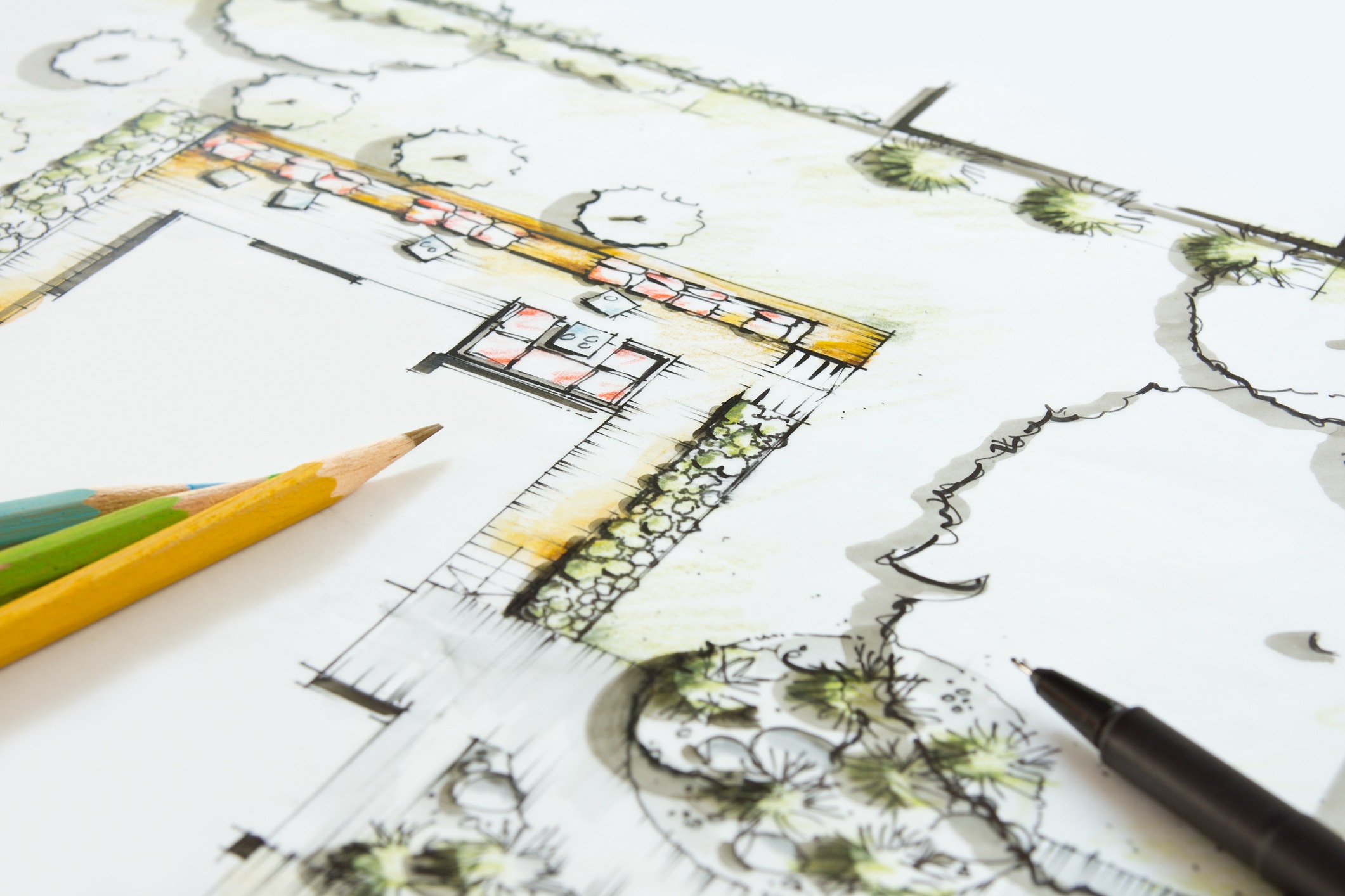 This image shows a colorful landscape architecture plan, with detailed pencil sketches of trees, pathways, and layout designs. Colored pencils and a fineliner lay atop.