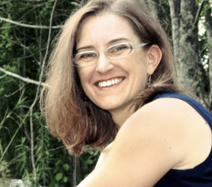 A smiling person with glasses is featured, wearing a blue sleeveless top. The background is an out-of-focus natural scene with green foliage.